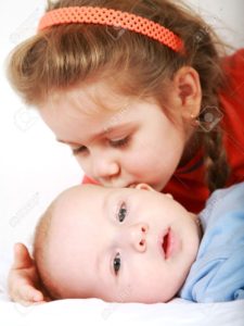 7521615-Cute-older-sister-giving-a-kiss-to-her-brother-Stock-Photo-baby