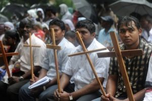 Indian Dalit - untouchable - Christians and Muslims sit in the rain during a protest rally against the National Commission for Scheduled Castes and Scheduled Tribes for its recent rejection of the demand for reservation for Dalit Christians and Muslims, in New Delhi on August 1, 2012. Thousands of protestors, church leaders, nuns, bishops and priests of the National United Christian Forum demanded that the United Progressive Alliance (UPA) government grant equal rights and reservation for the Dalit Christians and Muslims. AFP PHOTO/RAVEENDRAN